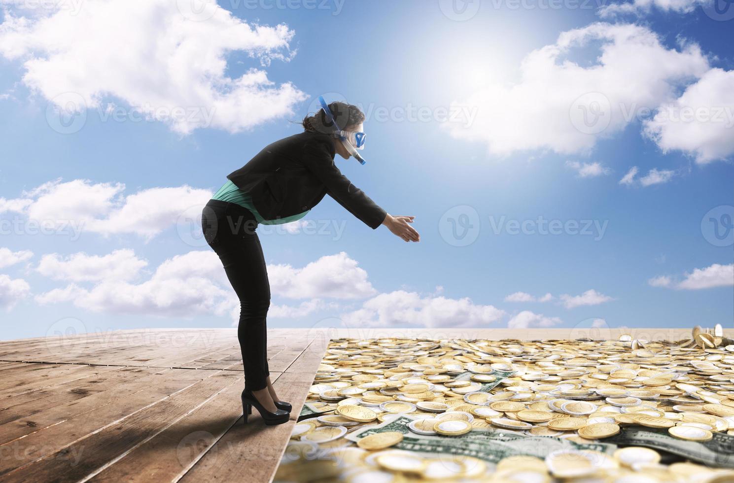 Geschäftsfrau ist bereit zu tauchen im ein groß Schwimmen Schwimmbad voll von Münze und Geld foto
