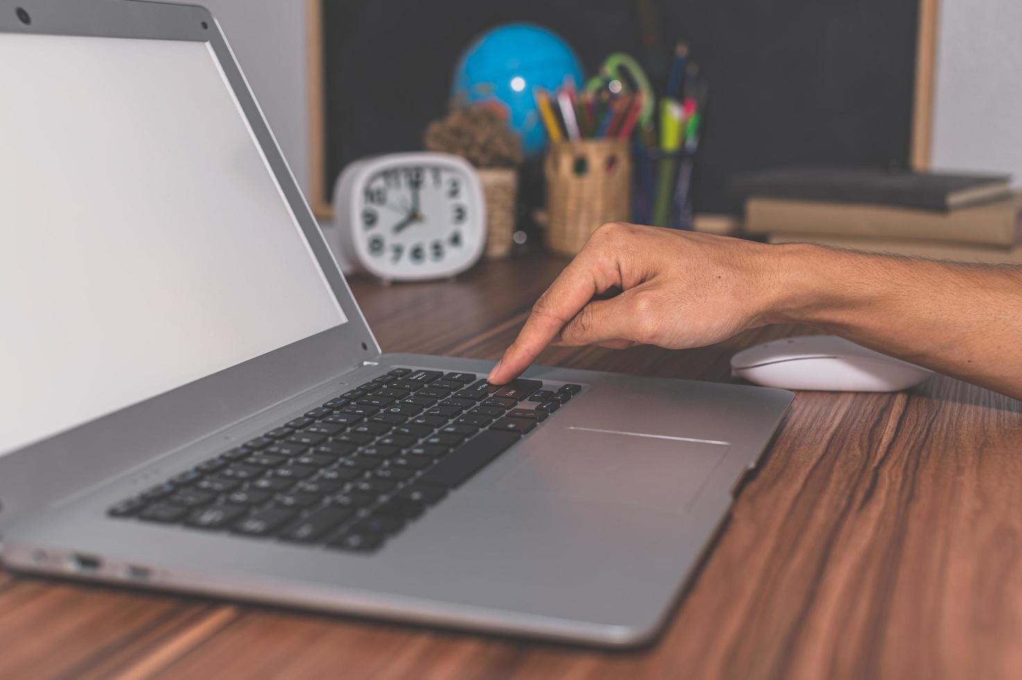 menschliche Hand, die Computer benutzt, um zu arbeiten und zu kommunizieren foto