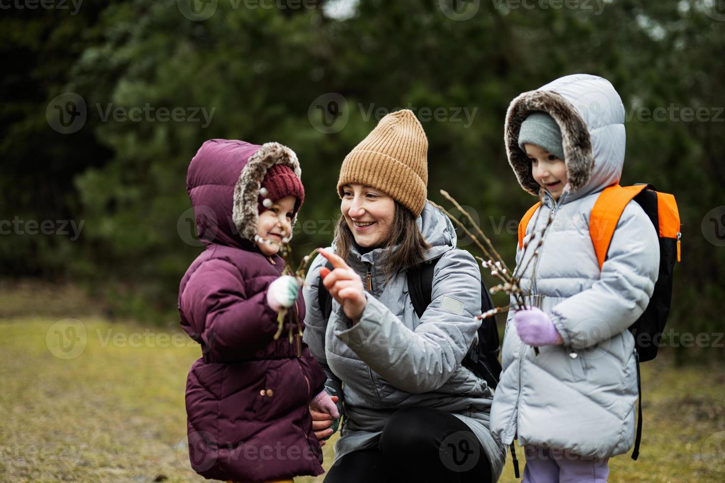 Mutter mit Töchter halten Weide Zweige im Wald. foto