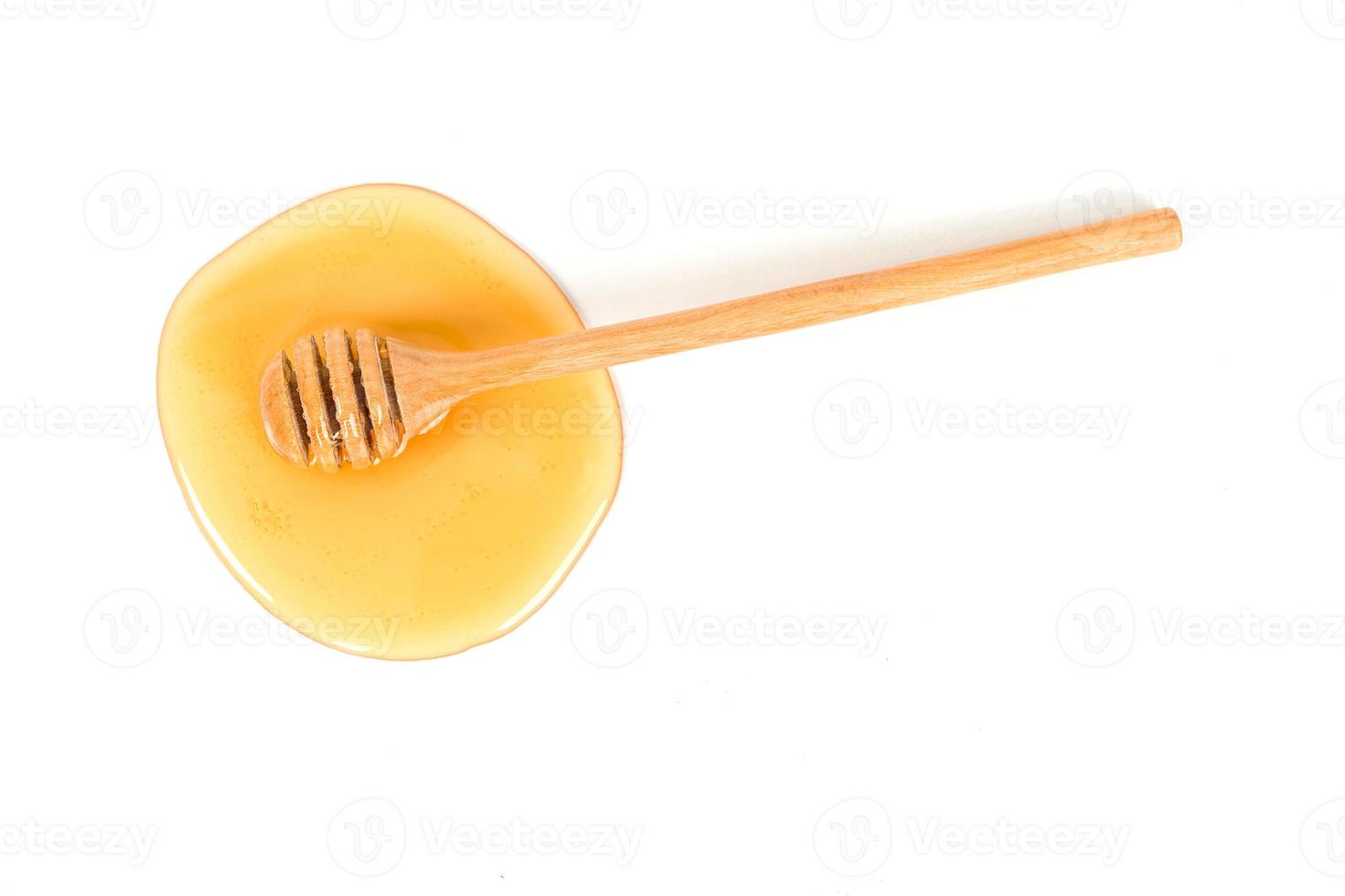 Honig mit Honig Schöpflöffel auf Weiß Hintergrund foto