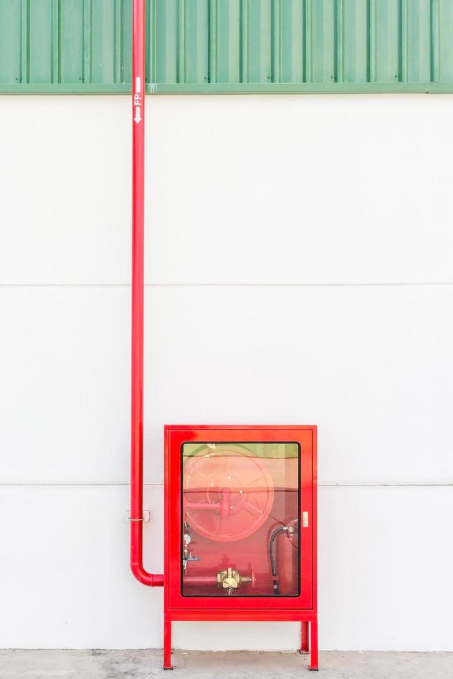 roter Feuerwehrschlauchschrank und Feuerlöscher foto
