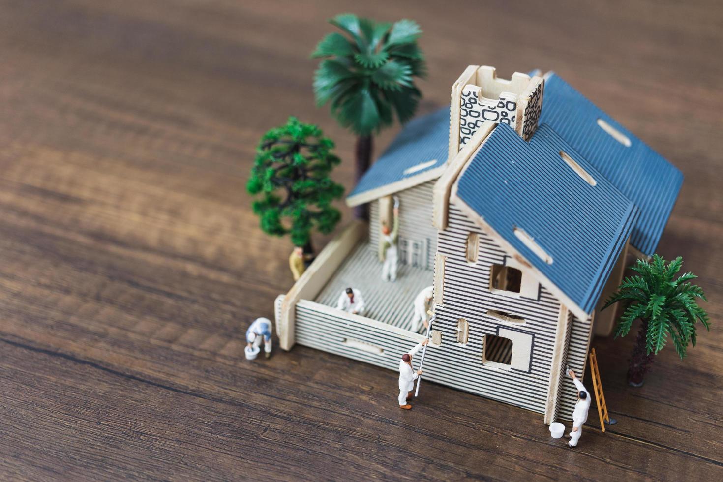 Miniaturarbeiter malen ein neues Haus, Renovierungskonzept foto