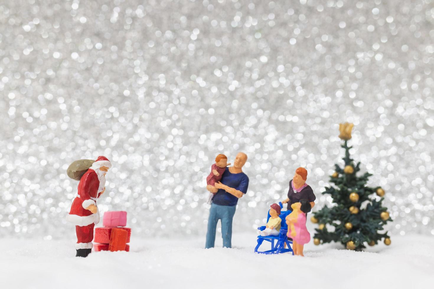 Miniatur-Weihnachtsmann und Kinder mit einem Schneehintergrund, Weihnachten und ein frohes neues Jahr-Konzept foto