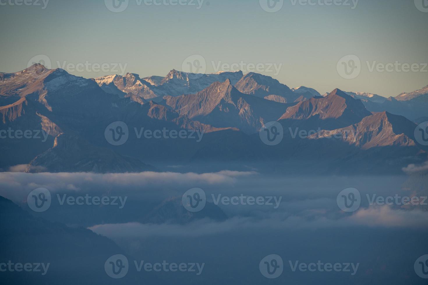 kalt bläulich Berg Landschaft im Nebel beim Sonnenaufgang foto