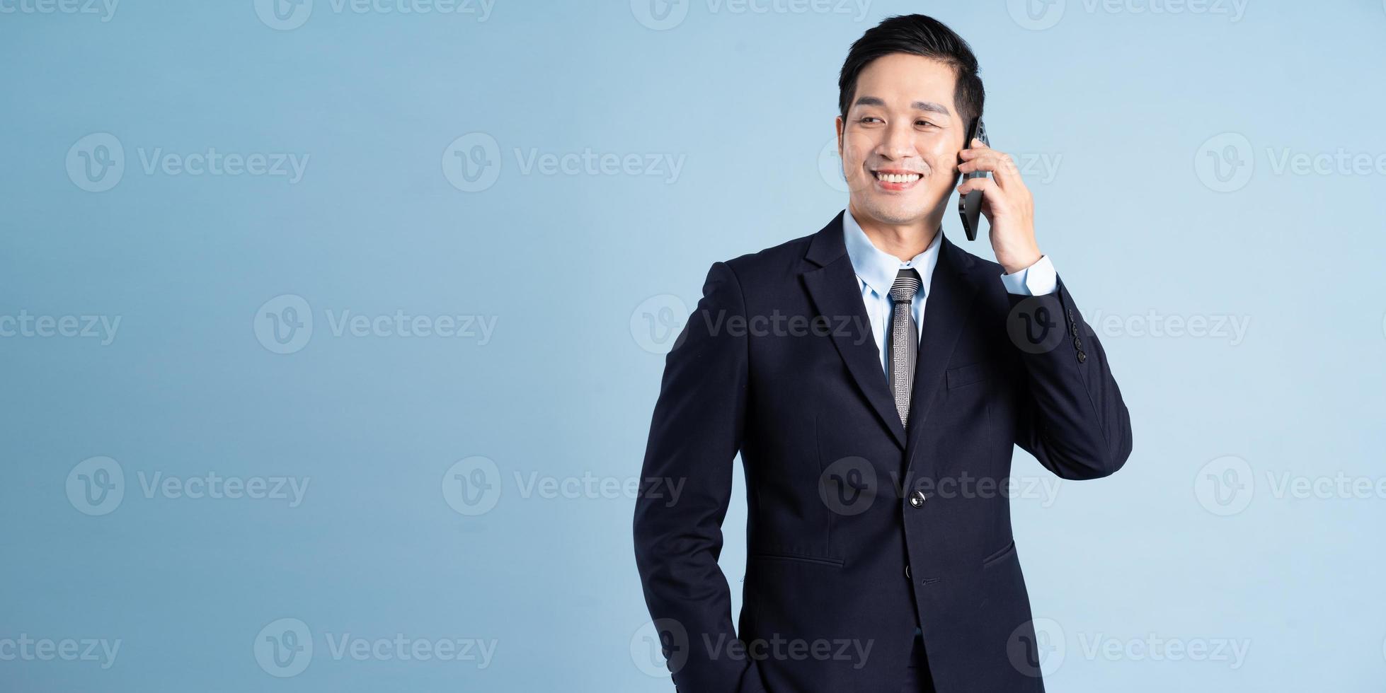 Porträt des asiatischen Geschäftsmannes im Anzug auf blauem Hintergrund foto