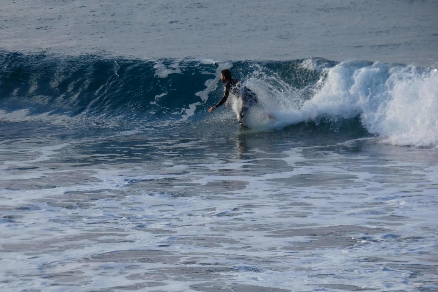 Surfer Reiten klein Ozean Wellen foto