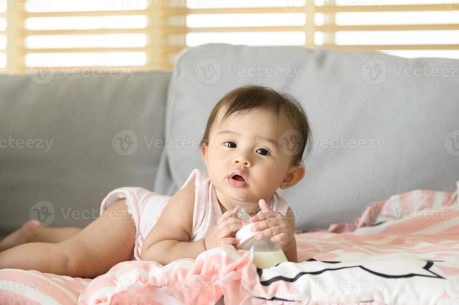 ein Baby Mädchen ist Trinken Milch Flasche, Familie, Kind, Kindheit und Elternschaft Konzept foto