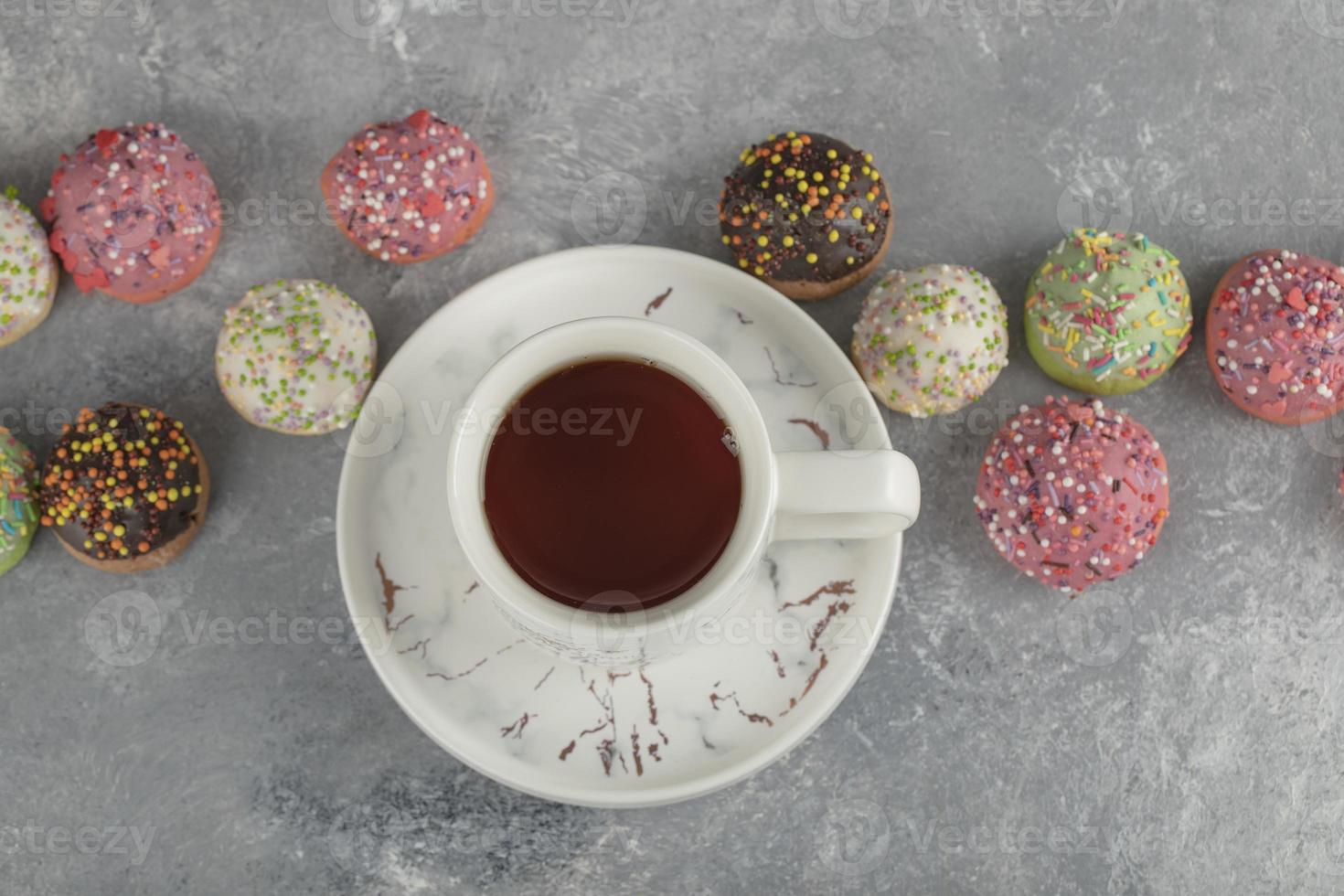 bunte süße Donuts mit einer Tasse Tee foto