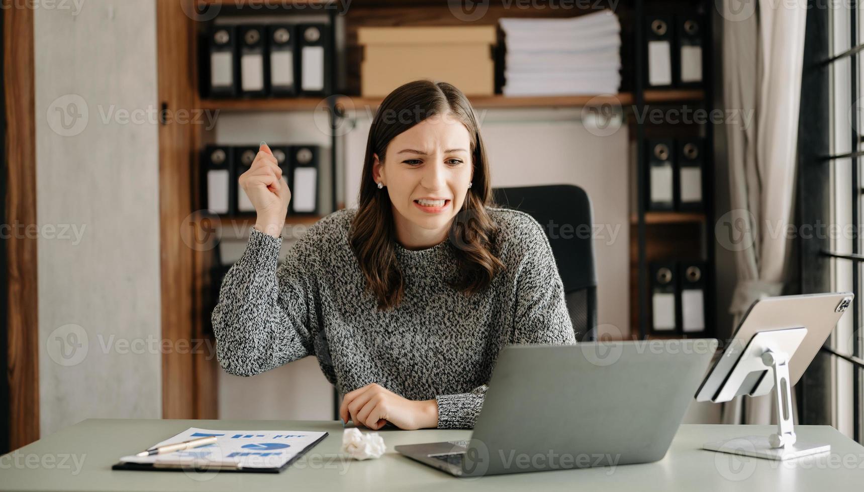 asiatisch Geschäft Frau ist betont, gelangweilt, und überdenken von Arbeiten auf ein Tablette beim das modern Büro. foto