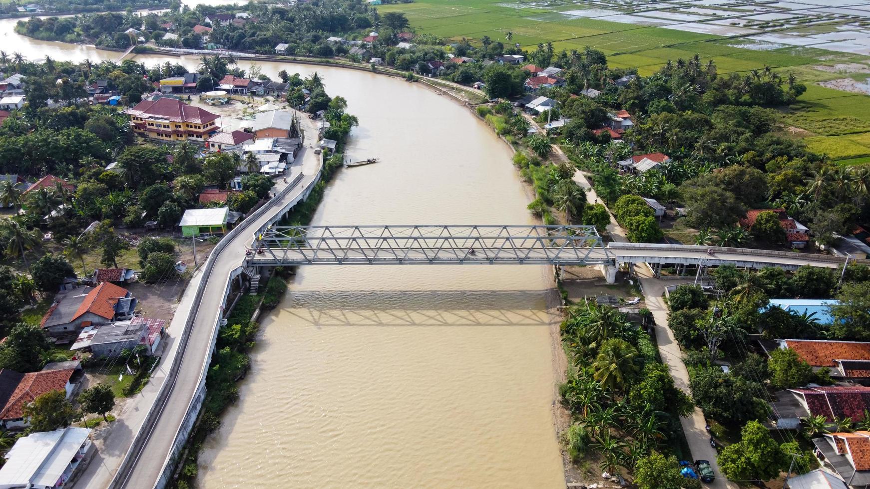 bekasi, indonesien 2021 - Luftdrohnenansicht einer langen Brücke am Ende des Flusses, die zwei Dörfer verbindet foto