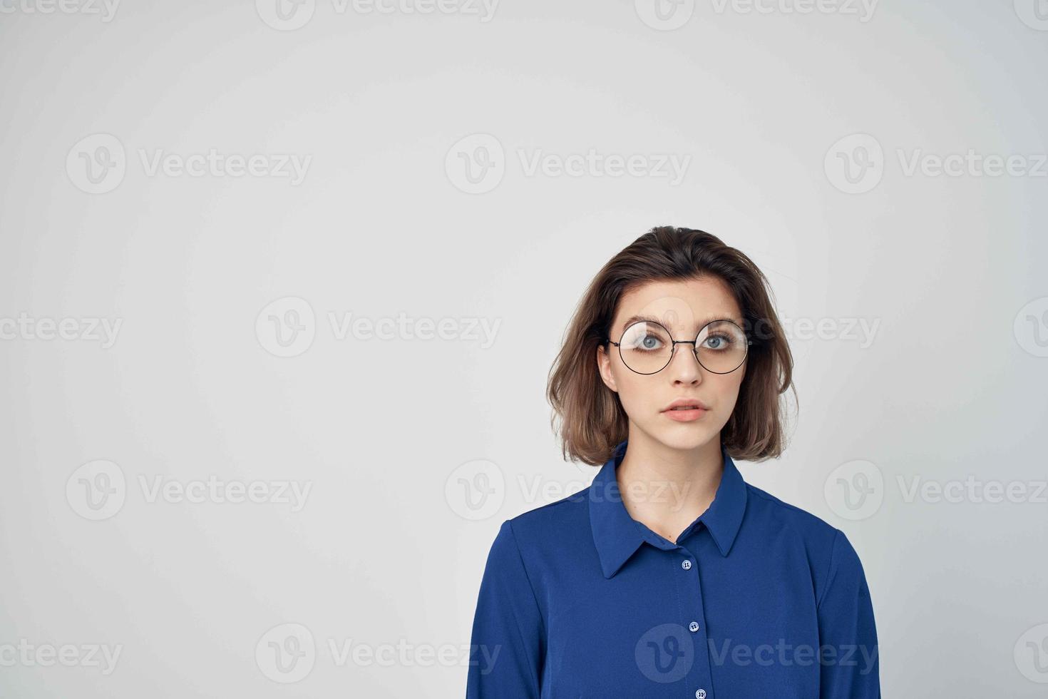 Frau im Blau Hemd tragen Brille Mode abgeschnitten Aussicht Licht Hintergrund foto