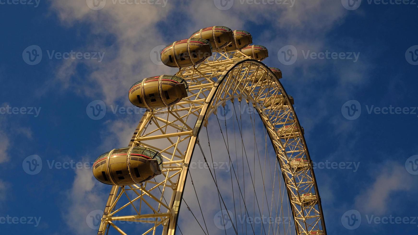 Ferris Rad im das Amüsement Park auf Hintergrund von Blau Himmel mit Wolken. niedrig Winkel Aussicht von ein groß Ferris Rad. foto