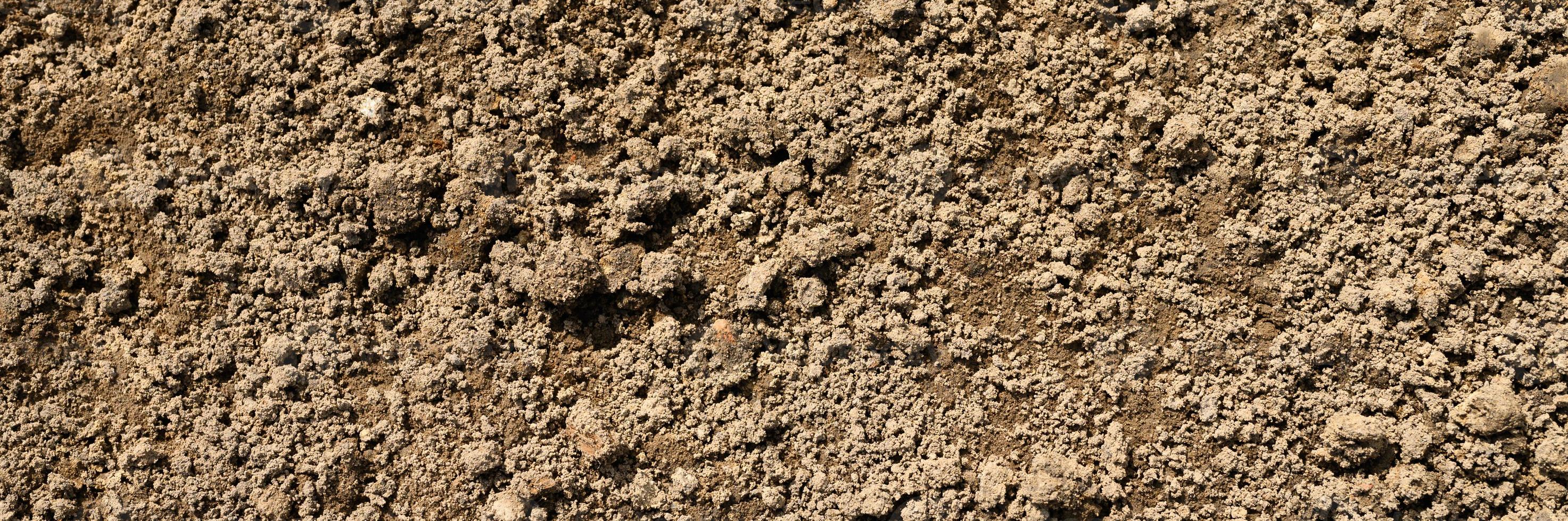 Hintergrundtextur von der glatten Oberfläche des Erdbodens foto