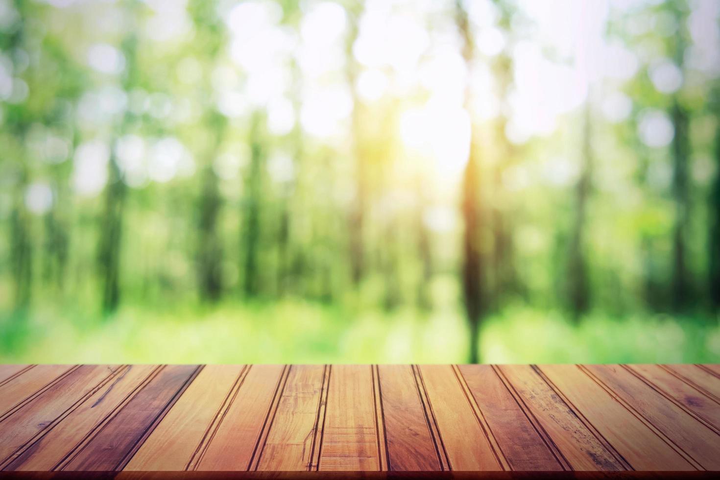 leeren Holz Tabelle auf verwischen Wald Hintergrund zum Design Produkt foto