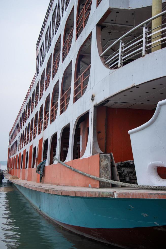 ein enorm Wasser Schiff Seite Sicht, schwebend auf das Fluss. ein groß starten beim das Fluss Dock, schwebend auf das Wasser. Süd-Ost asiatisch Wasser Transport Schiff Nahansicht Foto. ein modern schiffsseitig Sicht. foto