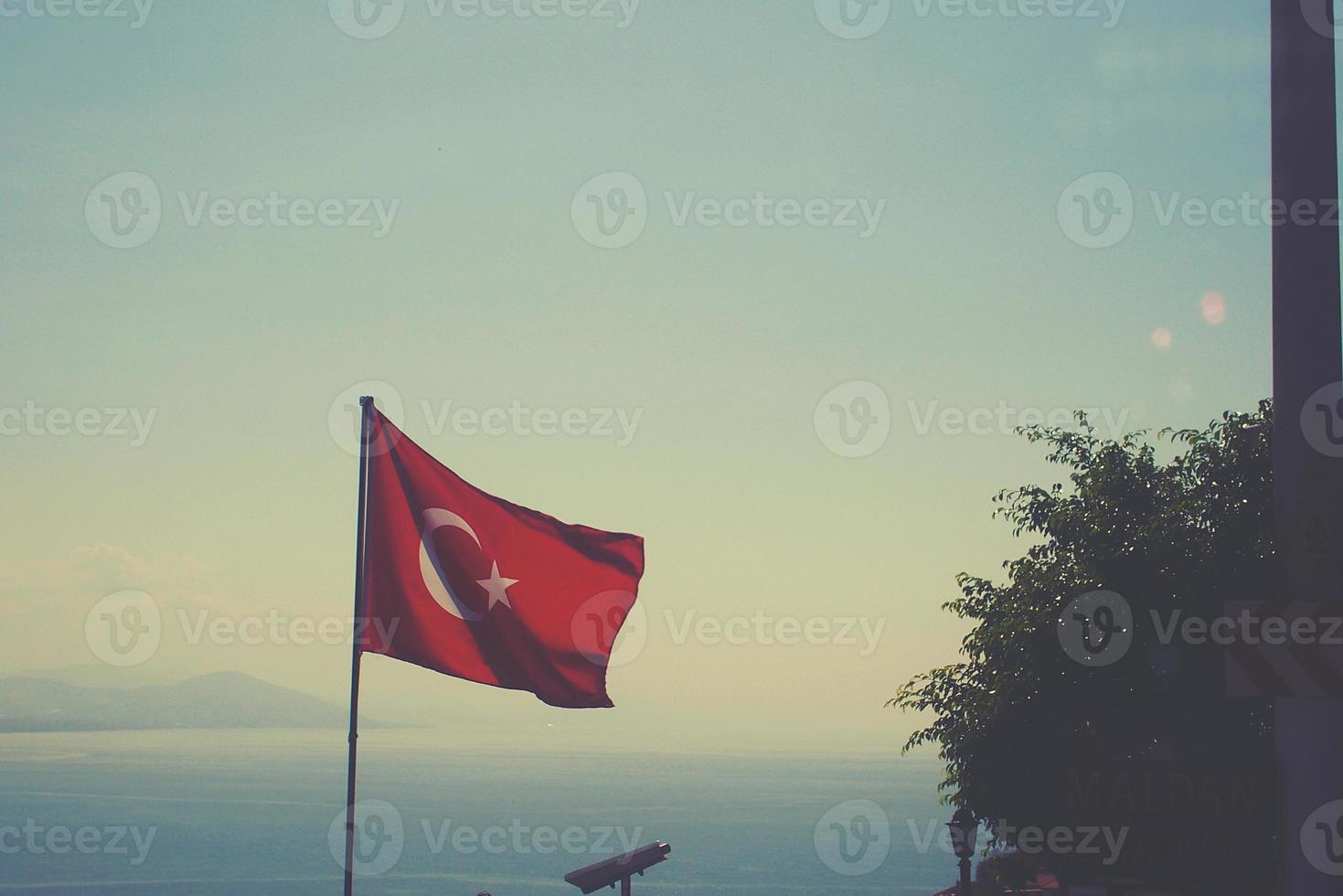 Türkisch Flagge winken im das Wind auf ein Sommer- warm Tag gegen das Himmel foto