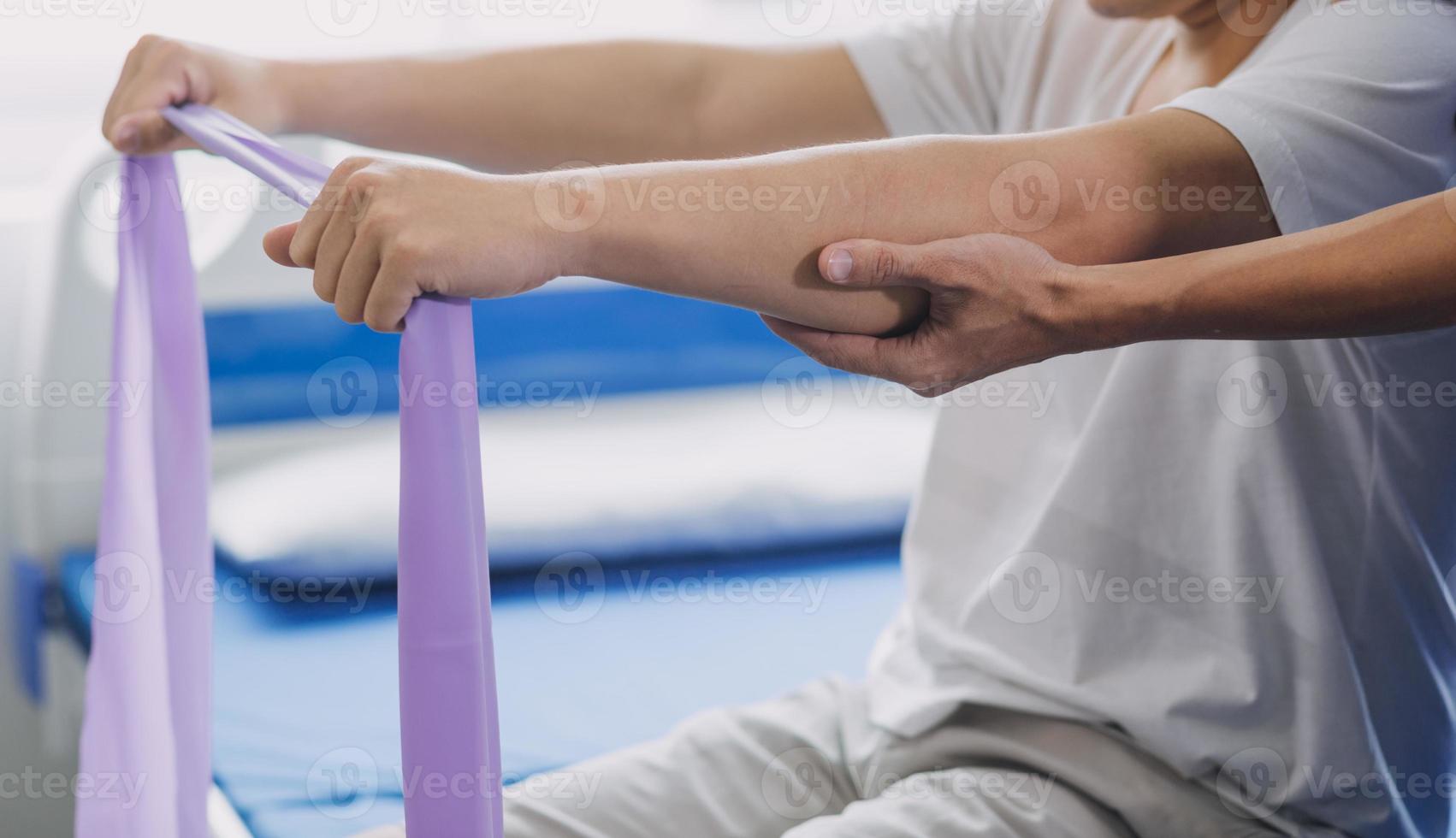 Arzt oder Physiotherapeut Arbeiten Prüfung Behandlung verletzt Arm von Athlet männlich geduldig, Dehnen und Übung, tun das Rehabilitation Therapie Schmerzen im Klinik. foto