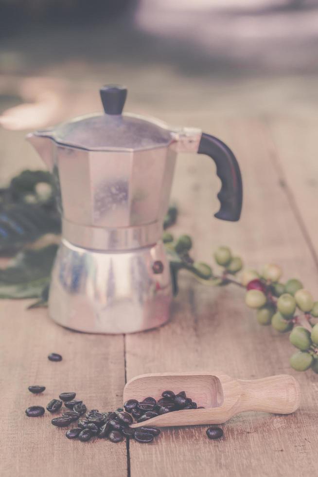 frisch Kaffee Bohnen auf Holz mit ein Moga Topf foto