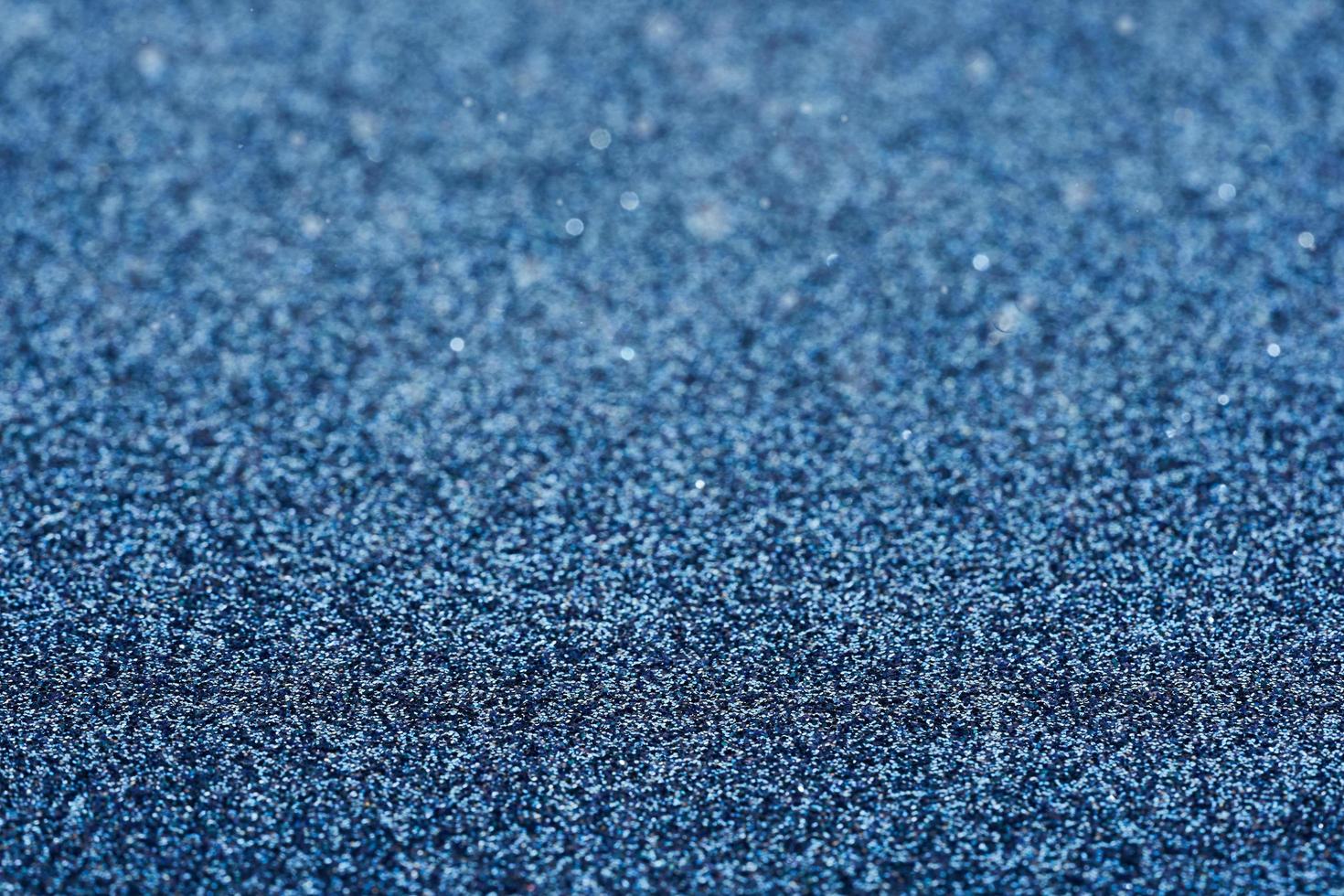 Blau Staub Funke funkeln Textur Weihnachten abstrakt funkeln Hintergrund. schließen oben Blau Staub Funke funkeln Textur Weihnachten abstrakt funkeln Hintergrund. Blau Bokeh funkeln foto