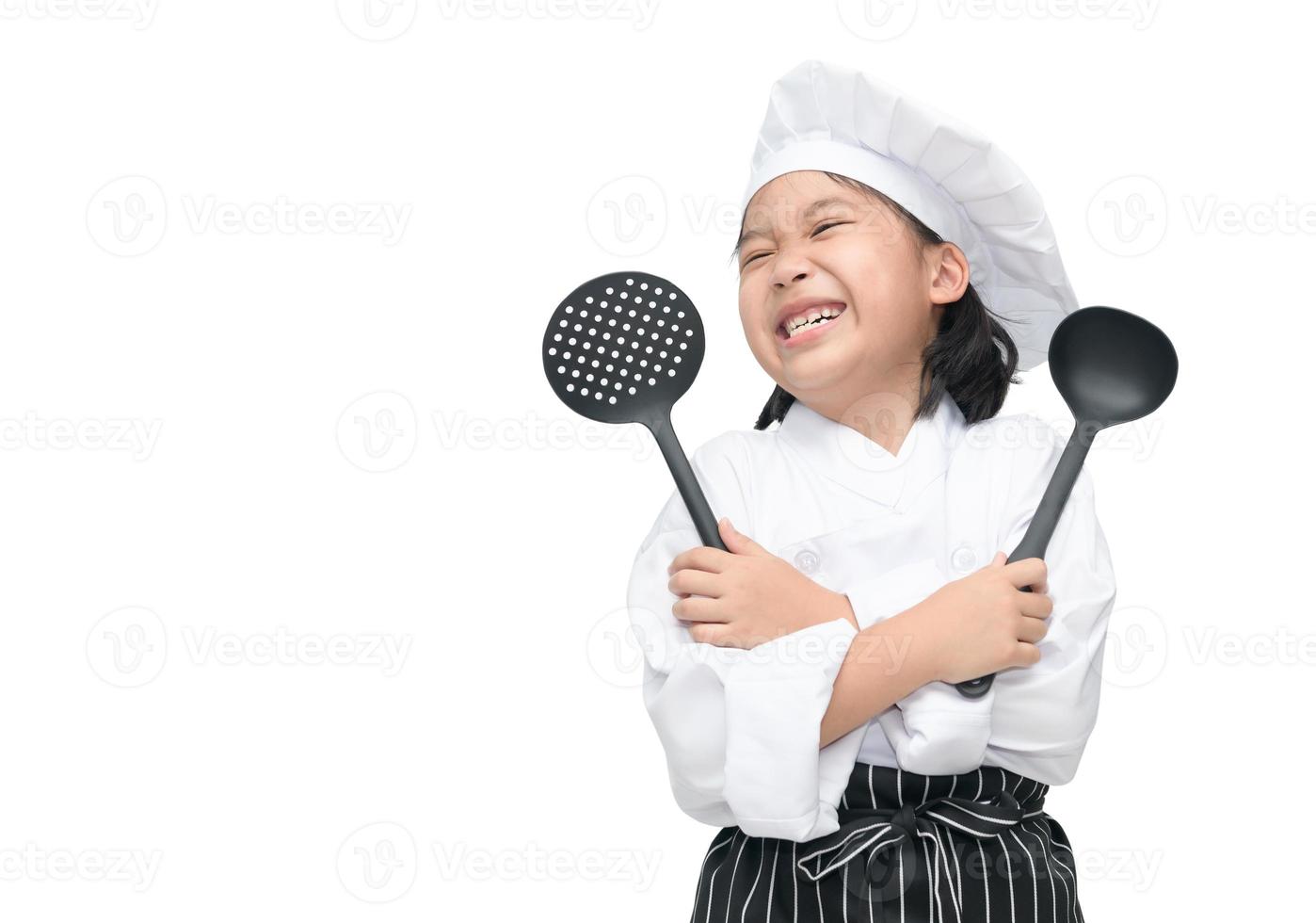 glücklich asiatisch Mädchen Koch halten Kochen Utensilien foto