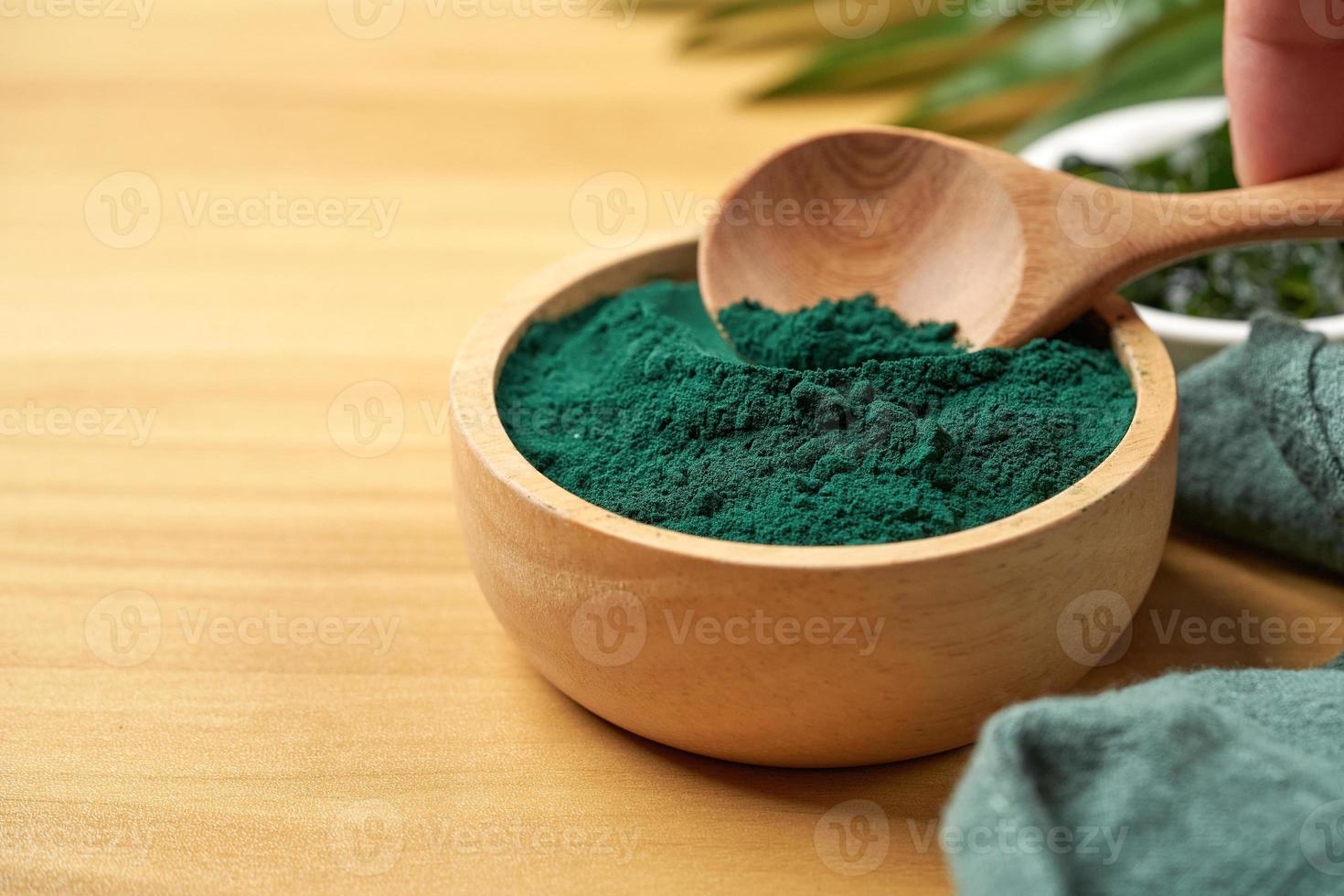 Laminaria oder Seetang Seetang und Spirulina Pulver im Holz Schüssel und Löffel Hintergrund. Spirulina Pulver mit konbu und Alge Essen auf Holz Tabelle Hintergrund. foto