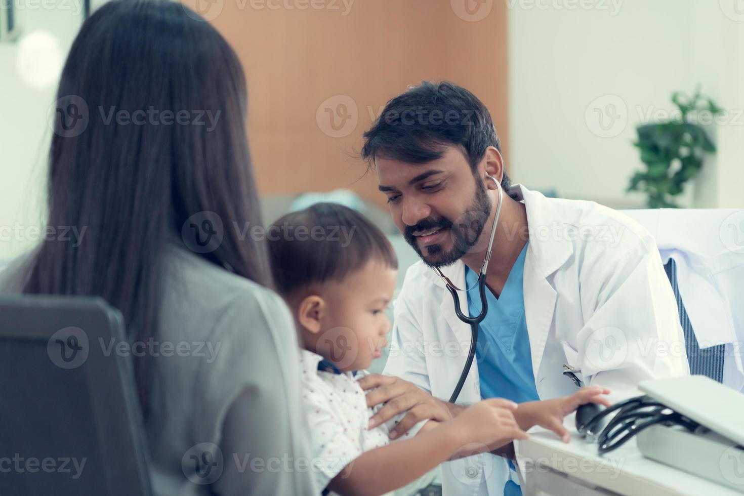 das Kinderarzt Muss Versuchen zu abspielen mit das Kind. welche Eltern gebracht zu prüfen das Körper zu machen es Einfacher zu untersuchen das Kind foto