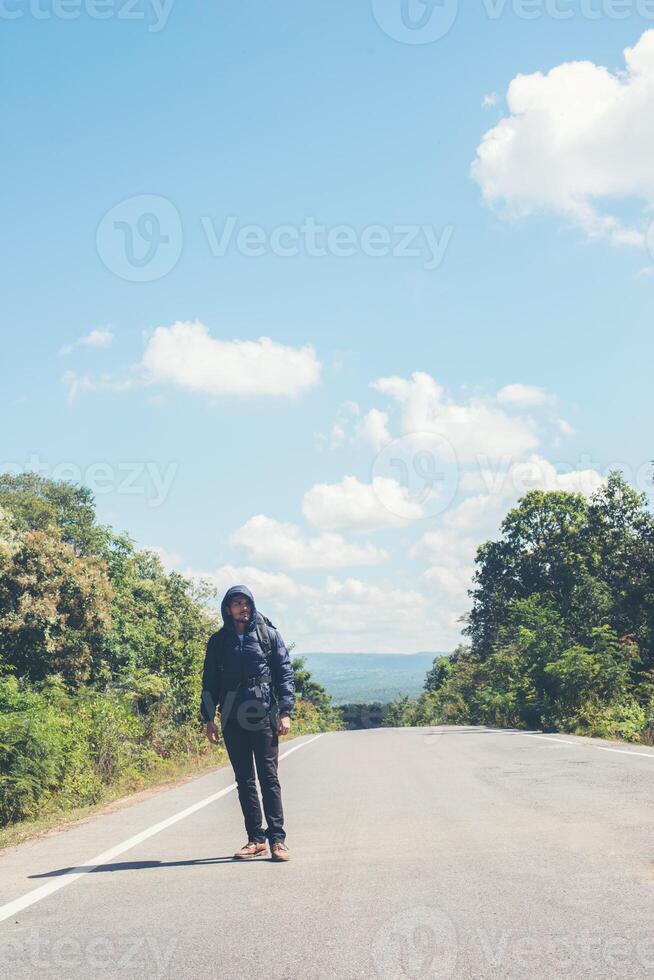 Abenteuer jung Mann Wandern im das Berge mit ein Rucksack. foto