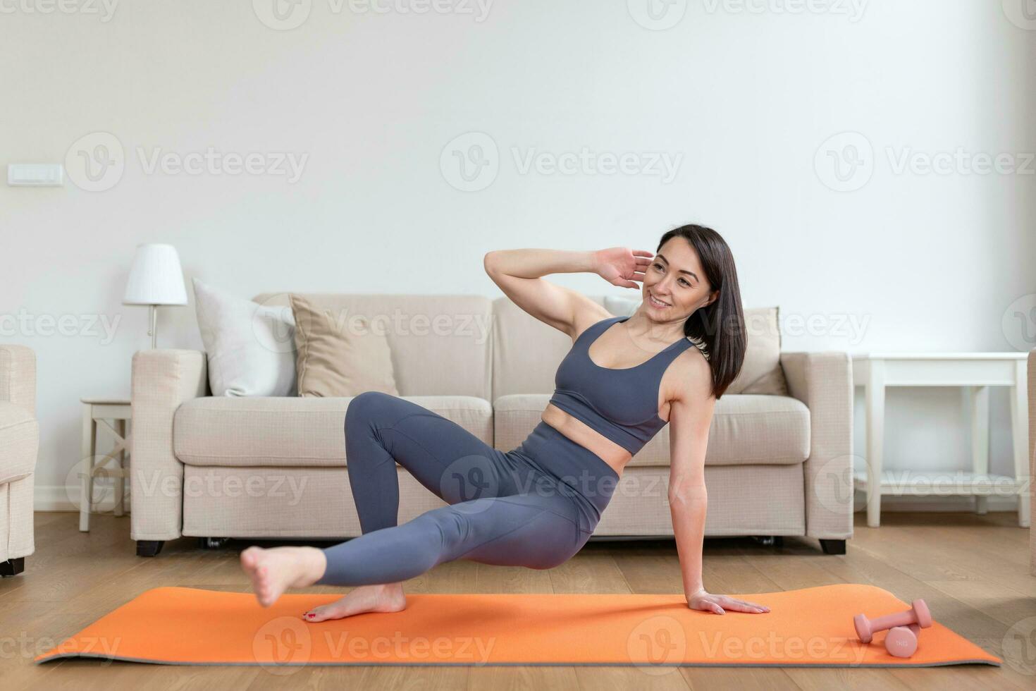 asiatisch Frau ausüben beim heim, dehnen. Zeit zum Yoga. attraktiv und gesund jung Frau tun Übungen während ruhen beim heim. jung Frau ausüben beim heim, Innere foto