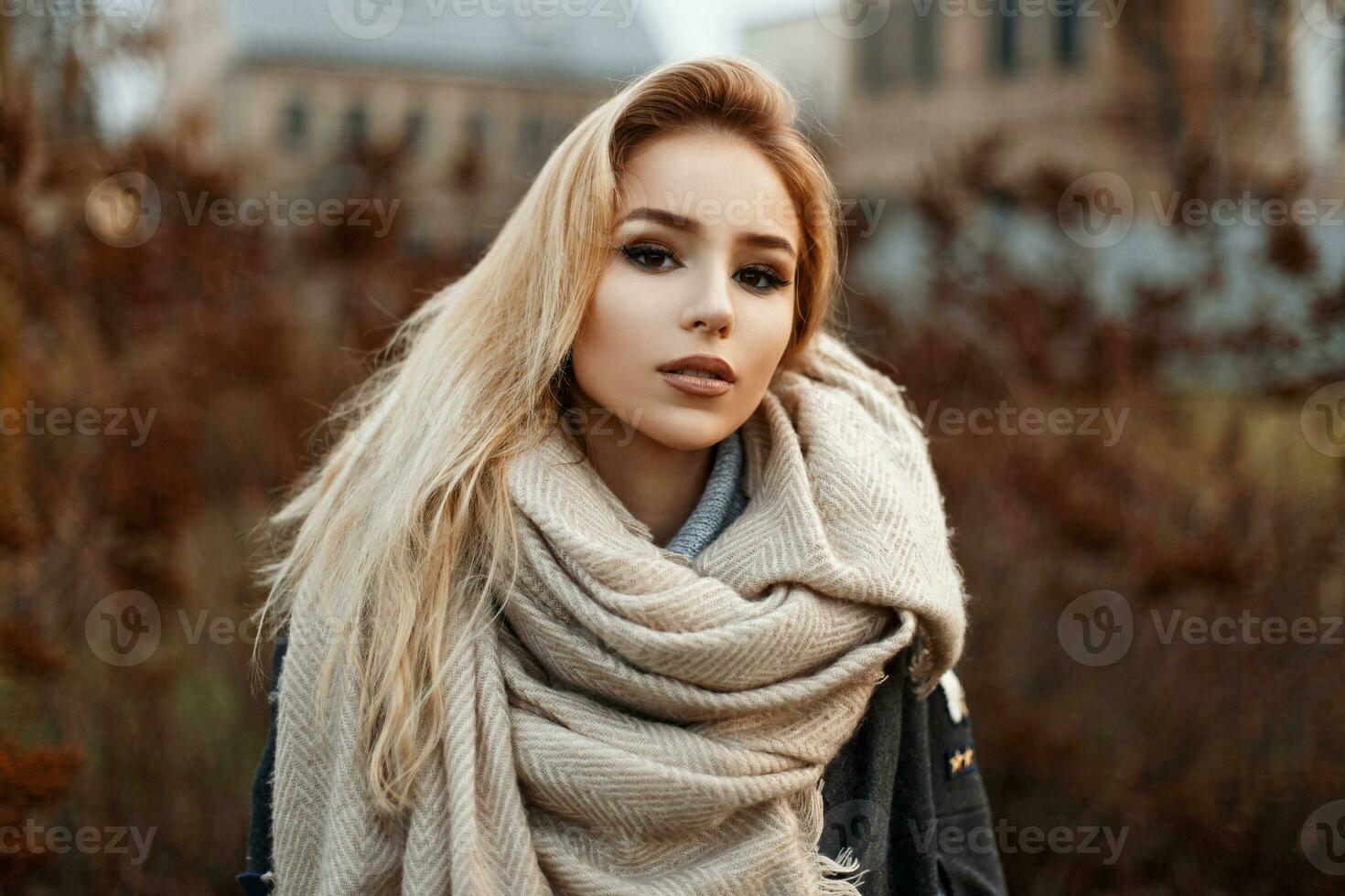 schön jung Frau im ein warm Schal Stehen im Herbst Park. foto