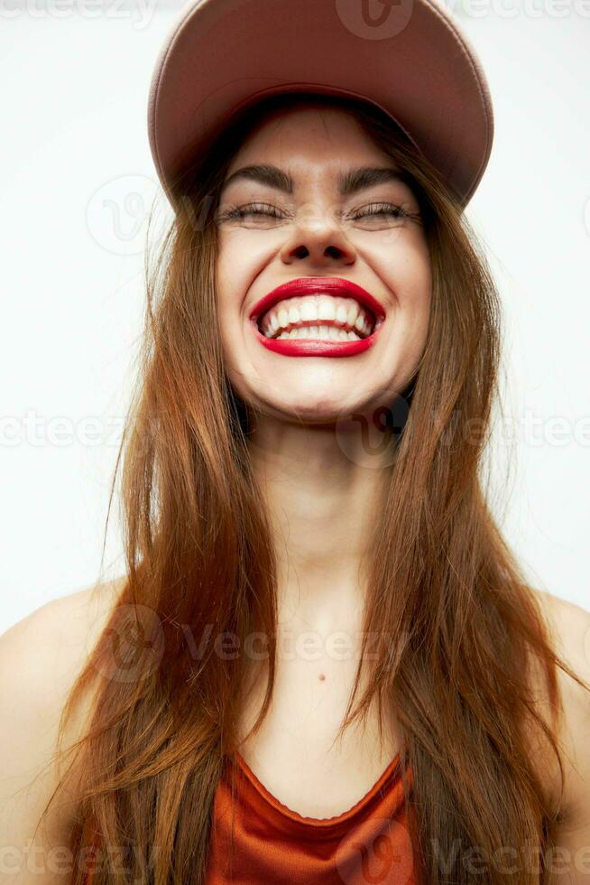 Frau mit ein Deckel Lächeln Spaß Charme auf ihr Kopf rot Lippen foto