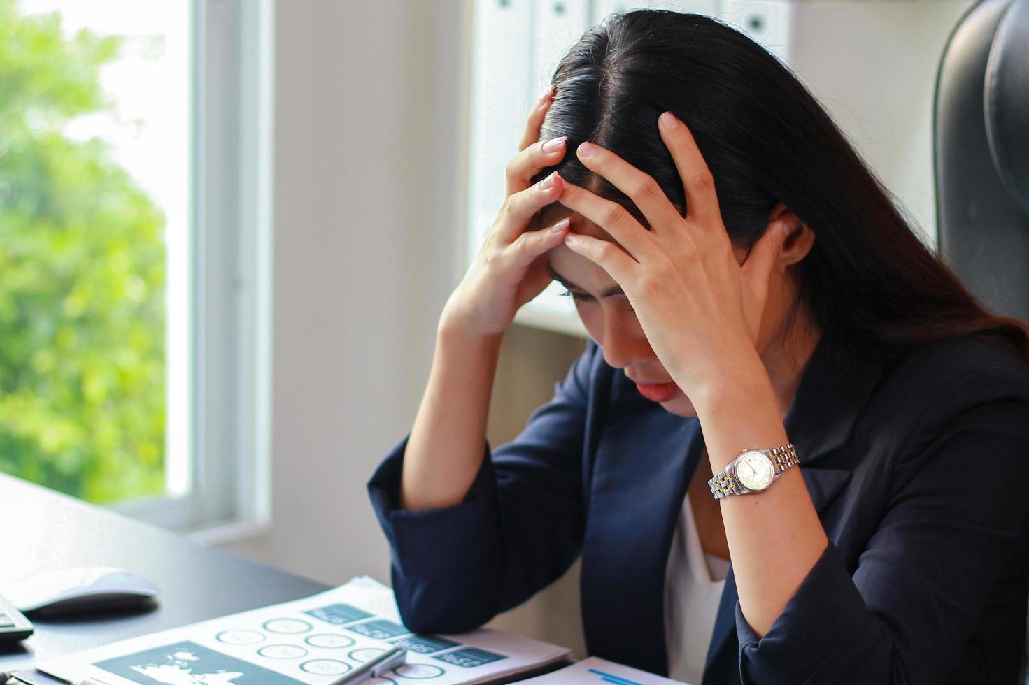 asiatische Geschäftsfrau sitzt im Büro mit Stress, Frauen sind nicht glücklich bei der Arbeit. foto