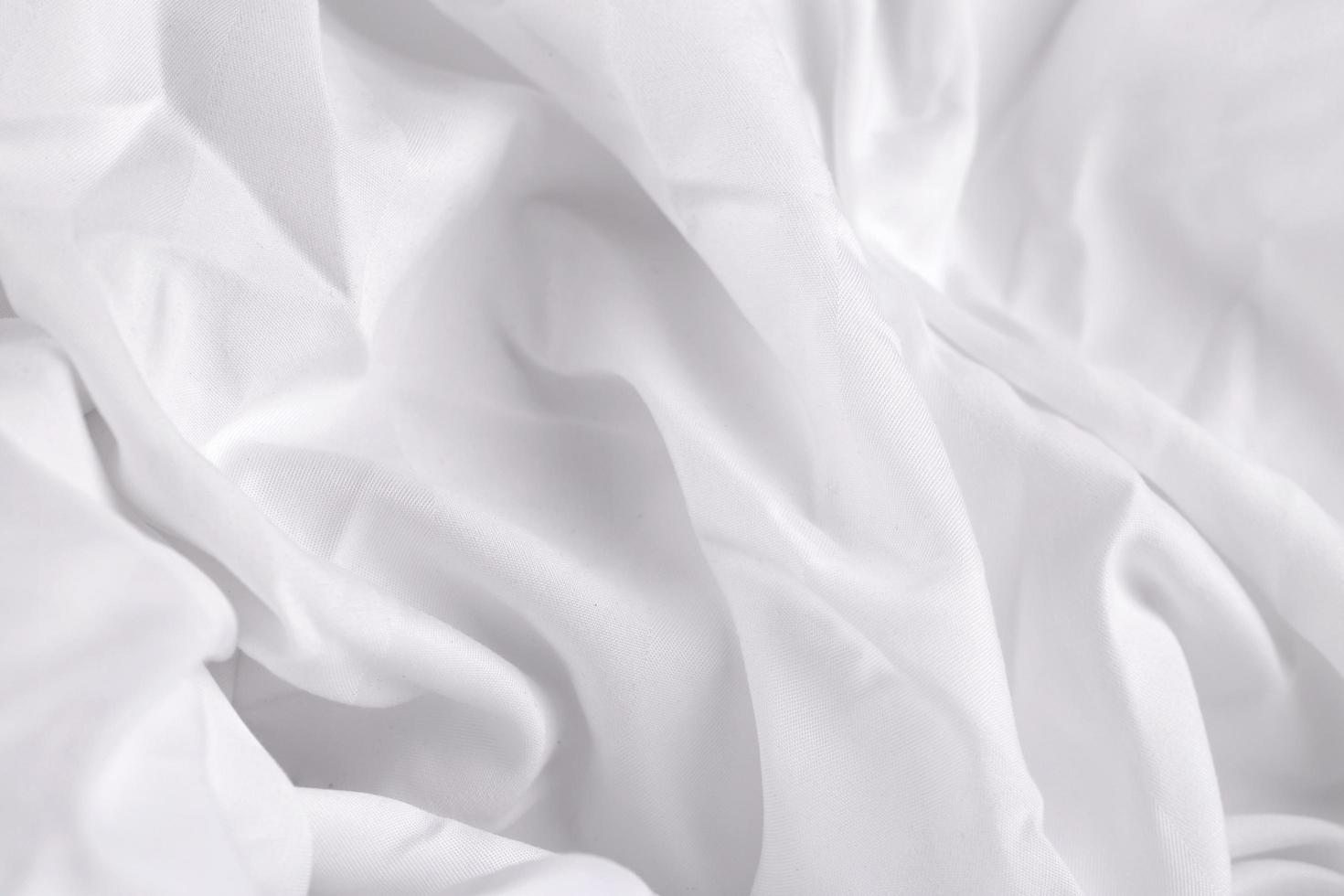 weiße Seide oder Satin Luxus Stoff Textur Hintergrund glatte elegante Stoff Bettlaken Textur foto