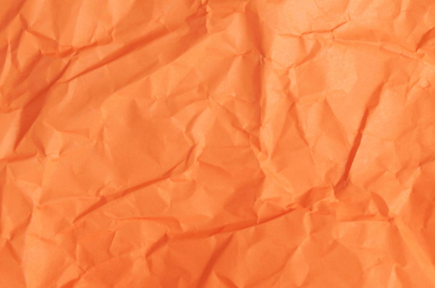 abstrakte Hintergrundbeschaffenheit mit orangefarbenem Papierblatt foto