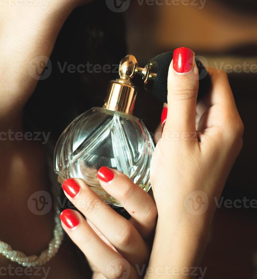 Frau, die Parfüm aufträgt foto