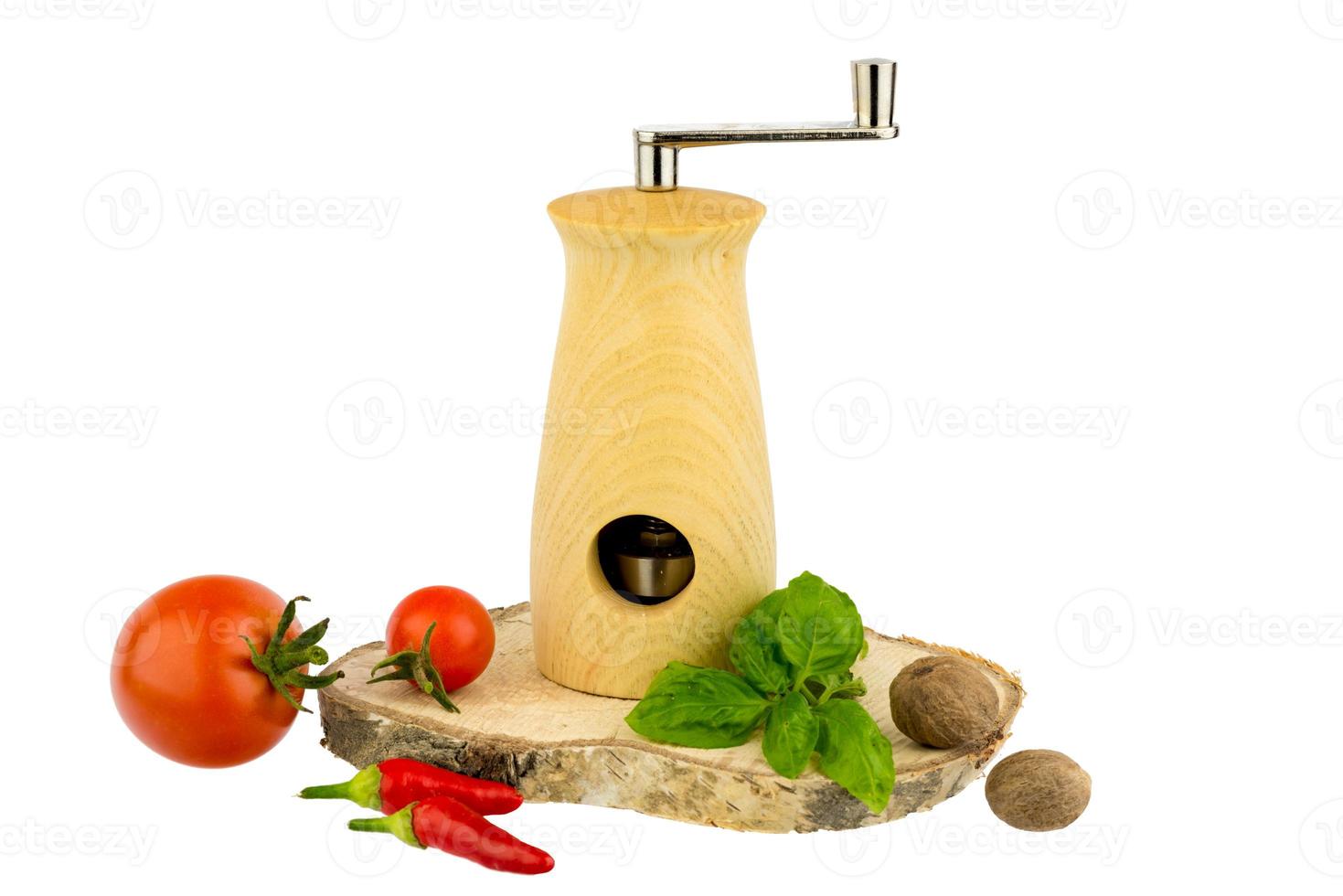 Muskatmühle mit Basilikumblättern Tomaten-Chili und Muskatnuss foto