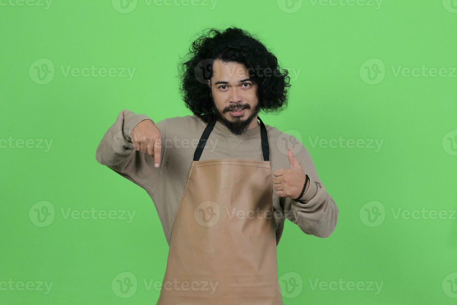 Pose von ein männlich Barmann tragen ein braun Schürze foto