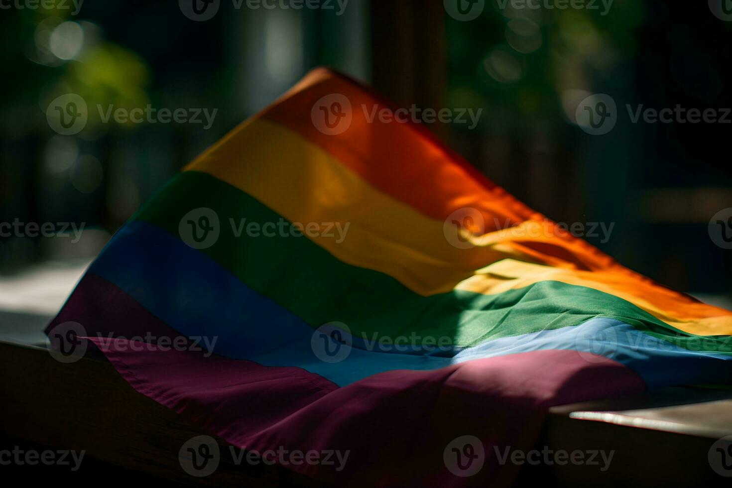 ein Regenbogen farbig Flagge auf ein Tabelle im ein dunkel Zimmer foto