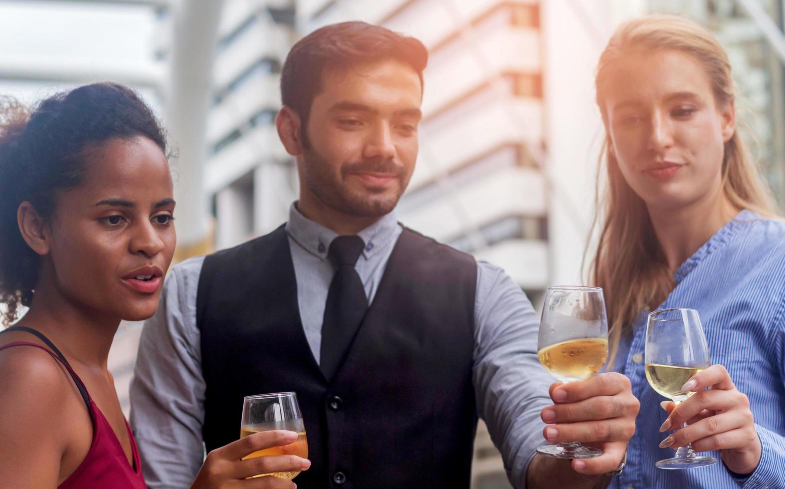 Geschäftsteam, das gerne den Sieg in den Büroalkoholgläsern zusammen mit Wein und Champagner feiert foto