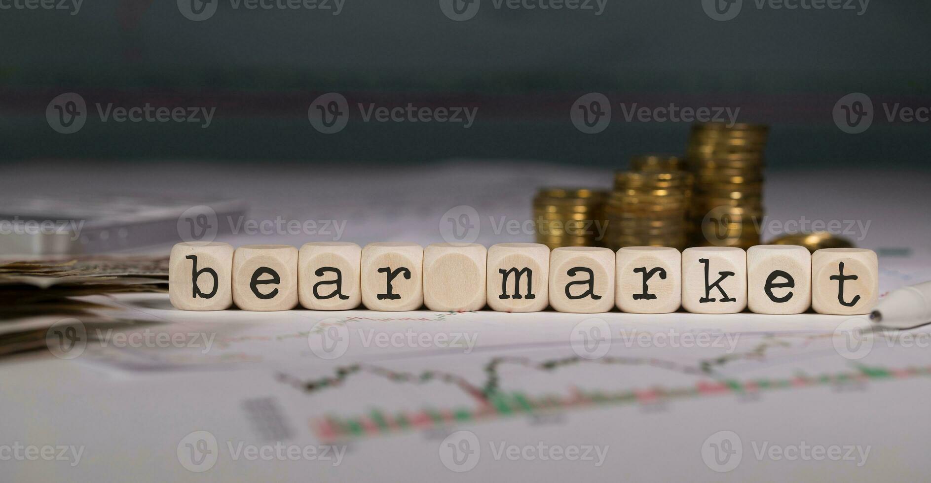 Wörter Bär Markt zusammengesetzt von hölzern Brief. Stapel von Münzen im das Hintergrund. foto