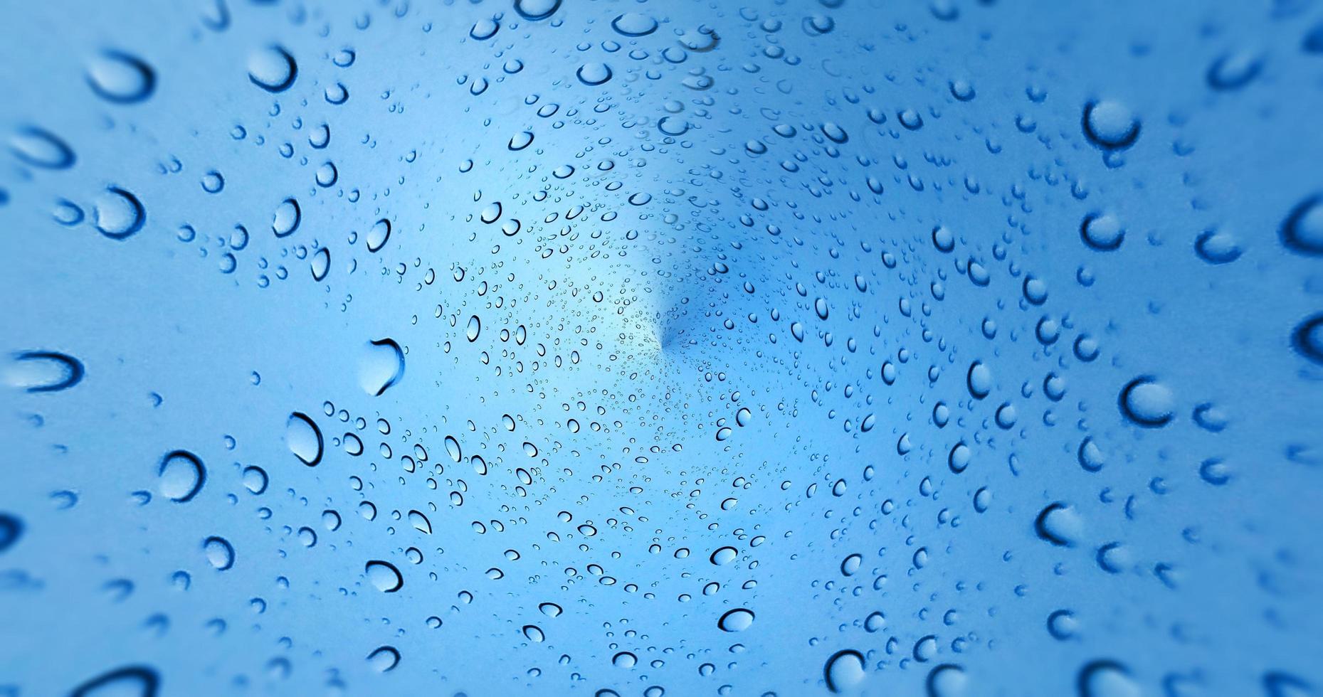 Regentropfen auf blauem Glasfensterhintergrund foto