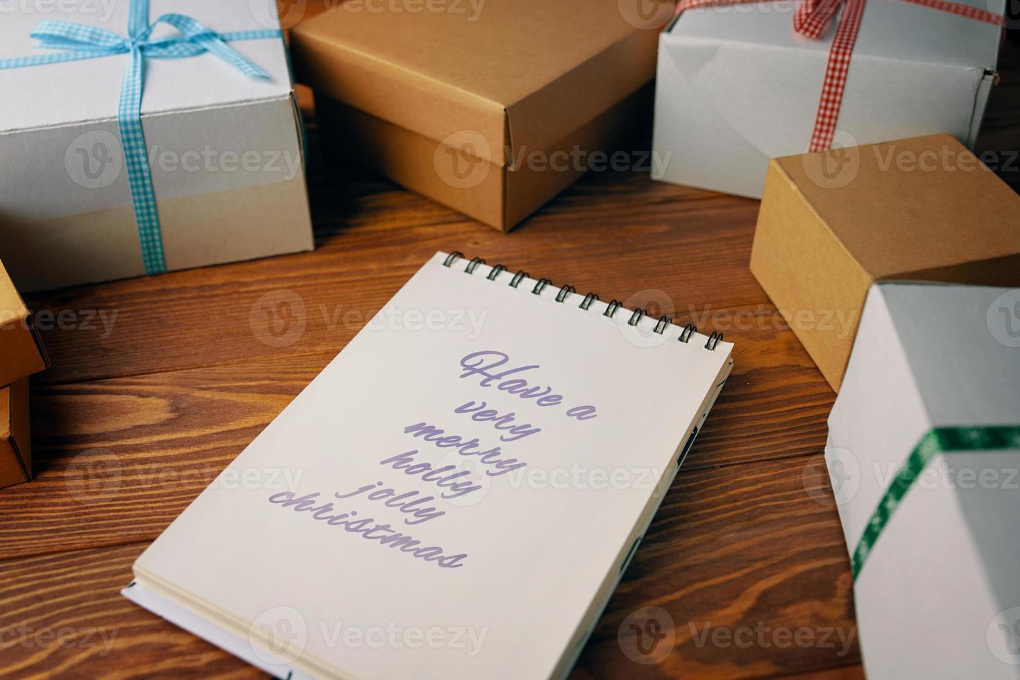 Holztisch mit Geschenkboxen und Notizblock foto