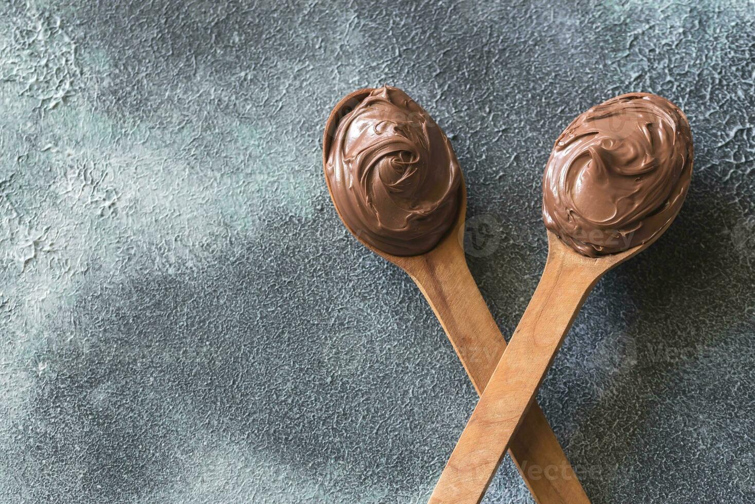 zwei hölzern Löffel von Schokolade Sahne foto