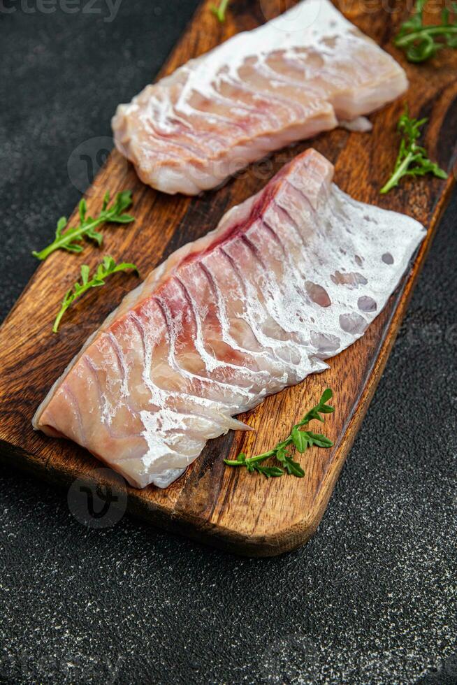 Filet von Weiß Fisch ohne Haut und Knochen frisch Meeresfrüchte gesund Mahlzeit Essen Snack auf das Tabelle Kopieren Raum Essen Hintergrund rustikal oben Aussicht pescatarian Diät foto