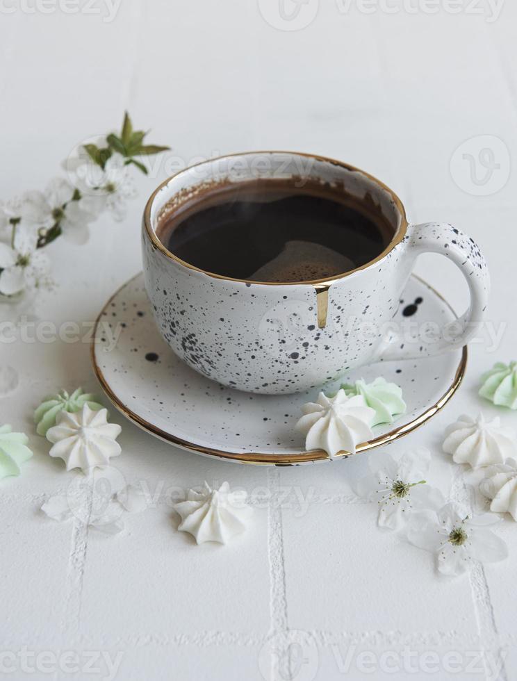 Tasse mit Kaffee und kleinen Baisers foto