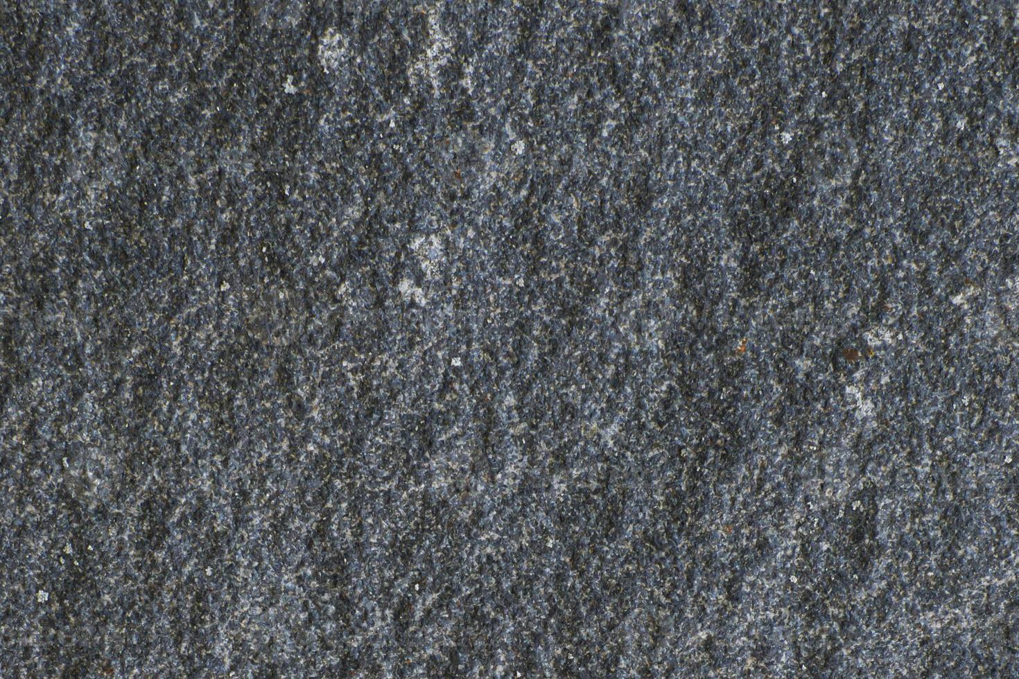 schwarze Steinstruktur mit Rissen und Chips, Hintergrundbild foto