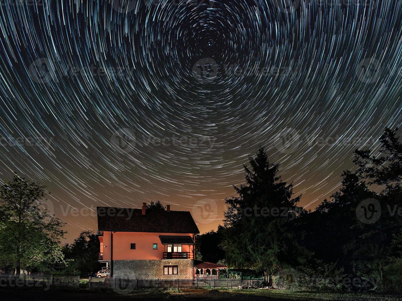 Sternspuren oberhalb des Hauses. Wohnhaus und die Sternenspuren am Himmel. der Nachthimmel ist astronomisch genau. foto