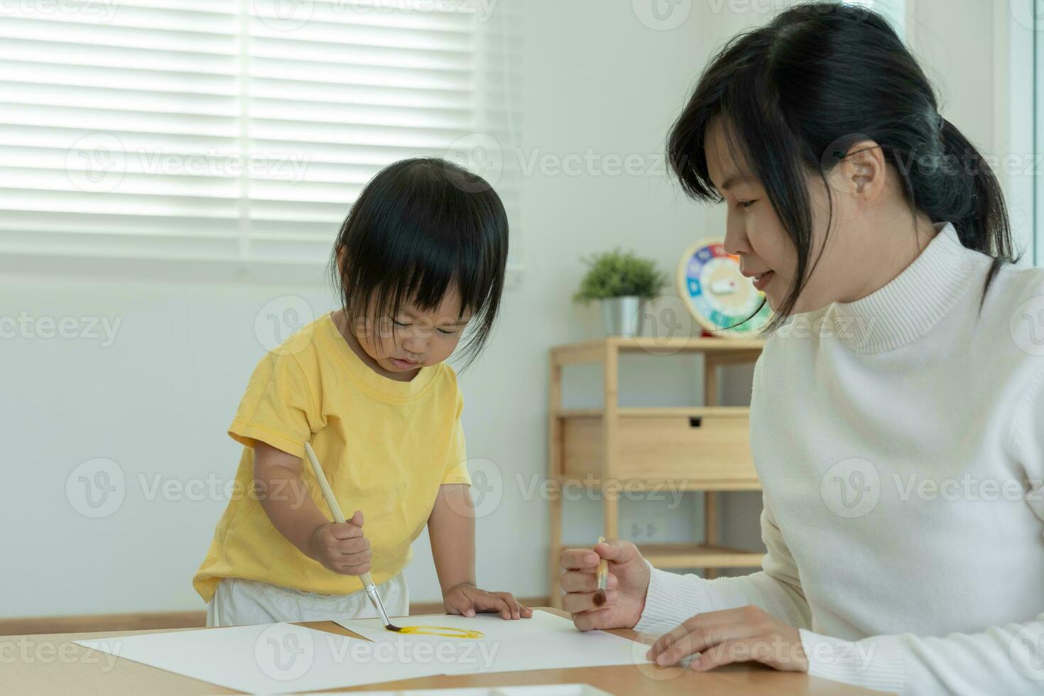 glücklich Asien Mutter spielen Lernen Farbe zum wenig Mädchen. komisch Familie ist glücklich und aufgeregt im das Haus. Mutter und Tochter haben Spaß Ausgaben Zeit zusammen. Urlaub, Aktivität foto