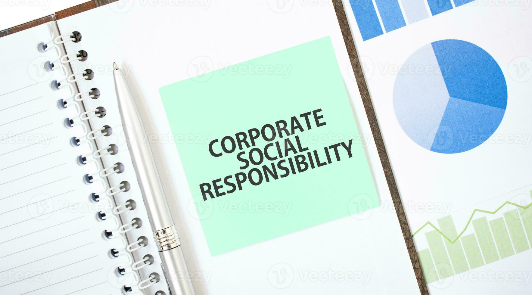 Grün Karte auf das Weiß Notizblock. Text korporativ Sozial Verantwortung. Geschäft Konzept foto