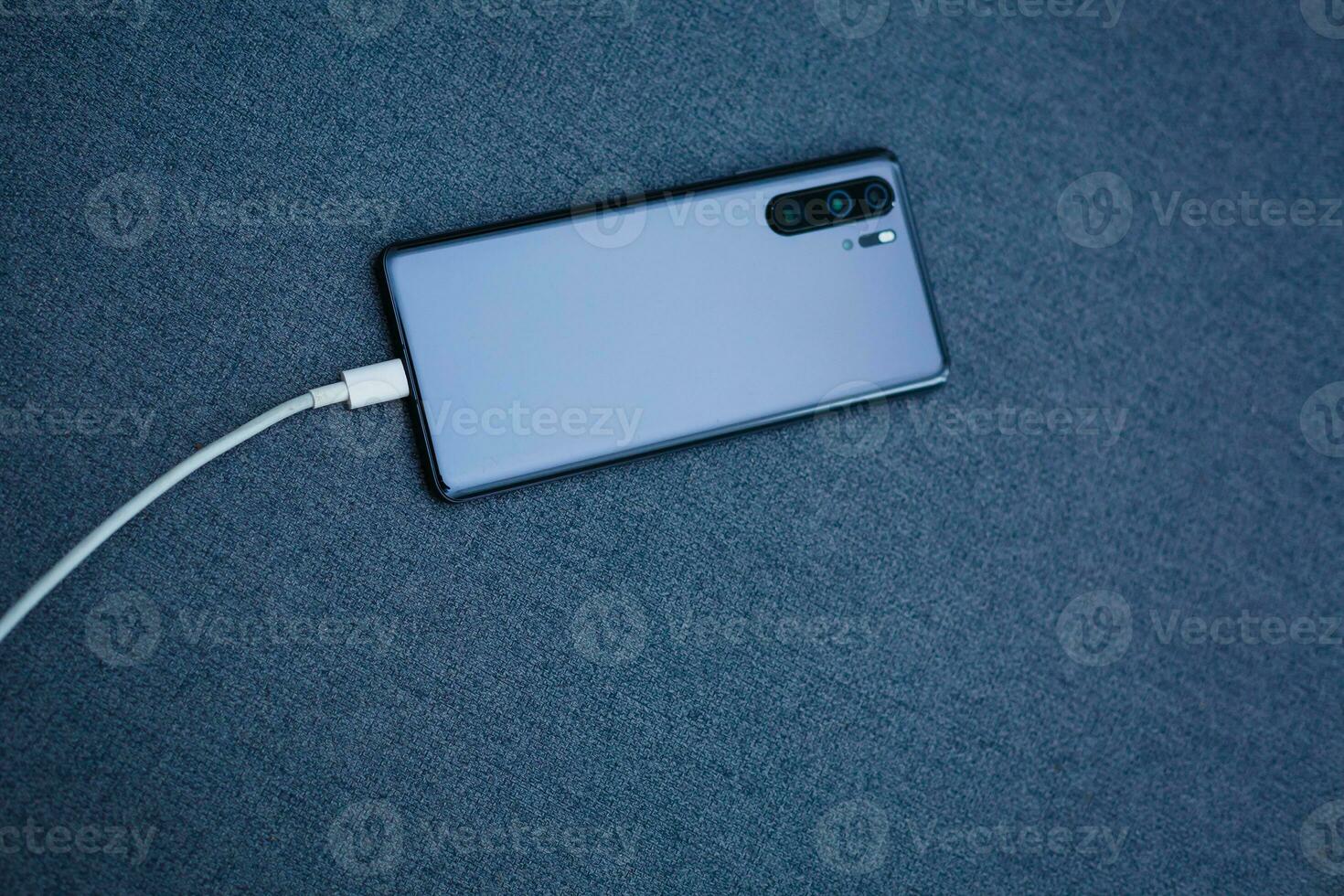 Handy, Mobiltelefon Clever Telefone Laden auf grau Hintergrund foto