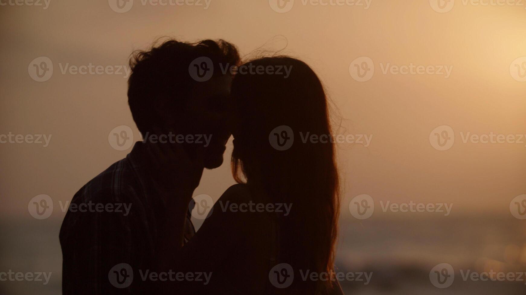 Porträt eines jungen Paares, das sich am Strand küsst foto